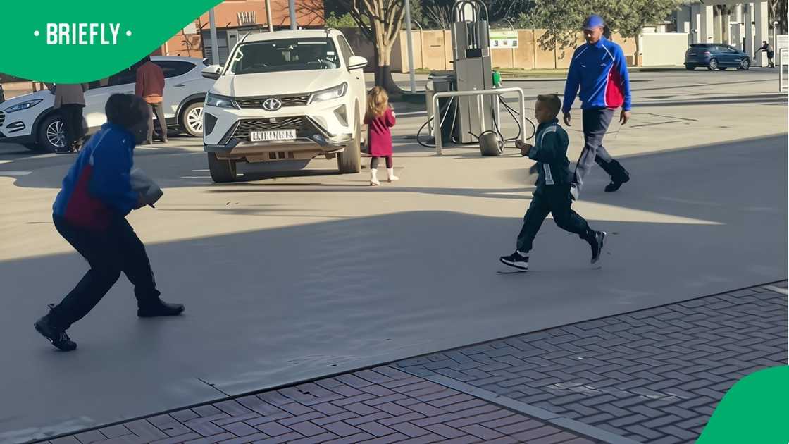 Engen petrol attendants play with children Engen petrol attendants play with children