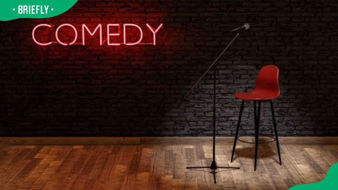 Stage with microphone and stool illuminated by a spotlight Stage with microphone and stool illuminated by a spotlight