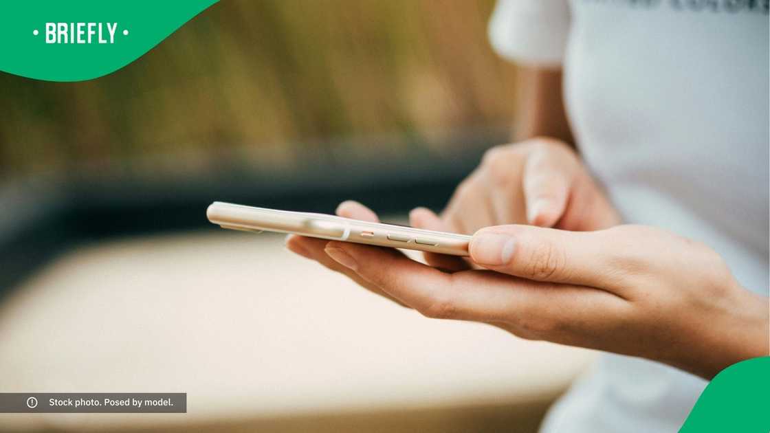 A woman typing on her phone. A woman typing on her phone.