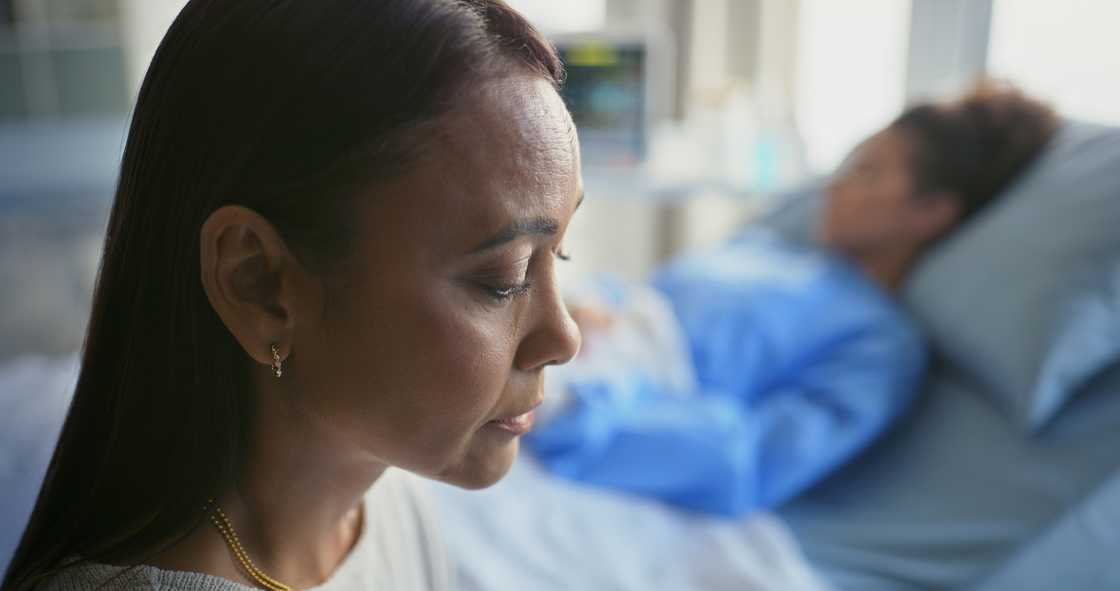 A woman visits a patient in the hospital A woman visits a patient in the hospital