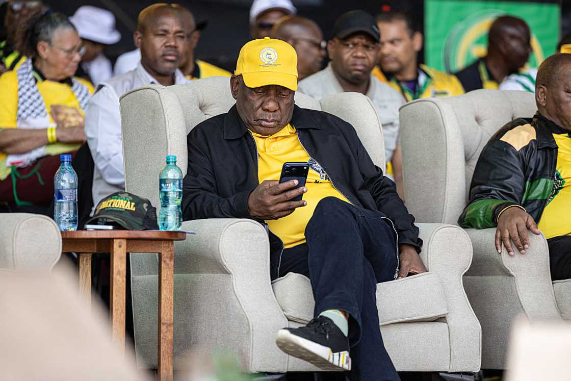 South African President Cyril Ramaphosa uses his phone during the African National Congress's (ANC) 2026 local government election manifesto launch in Diepsloot near Johannesburg on August 23, 2026, ahead of the country's upcoming municipal elections South African President Cyril Ramaphosa uses his phone during the African National Congress's (ANC) 2026 local government election manifesto launch in Diepsloot near Johannesburg on August 23, 2026, ahead of the country's upcoming municipal elections