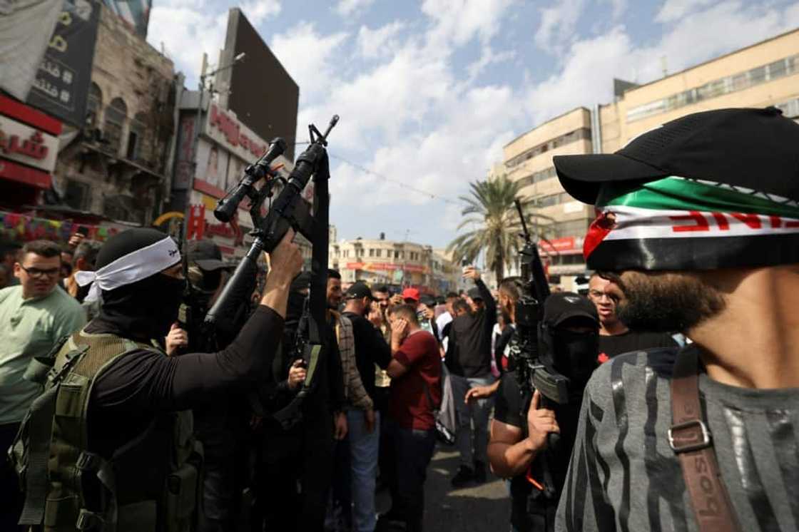 Efforts toward peace between Israel and the Palestinians have stalled for years. This picture shows Palestinian militants fire into the air during a funeral in Nablus in the occupied West Bank on October 23, 2022 Efforts toward peace between Israel and the Palestinians have stalled for years. This picture shows Palestinian militants fire into the air during a funeral in Nablus in the occupied West Bank on October 23, 2022