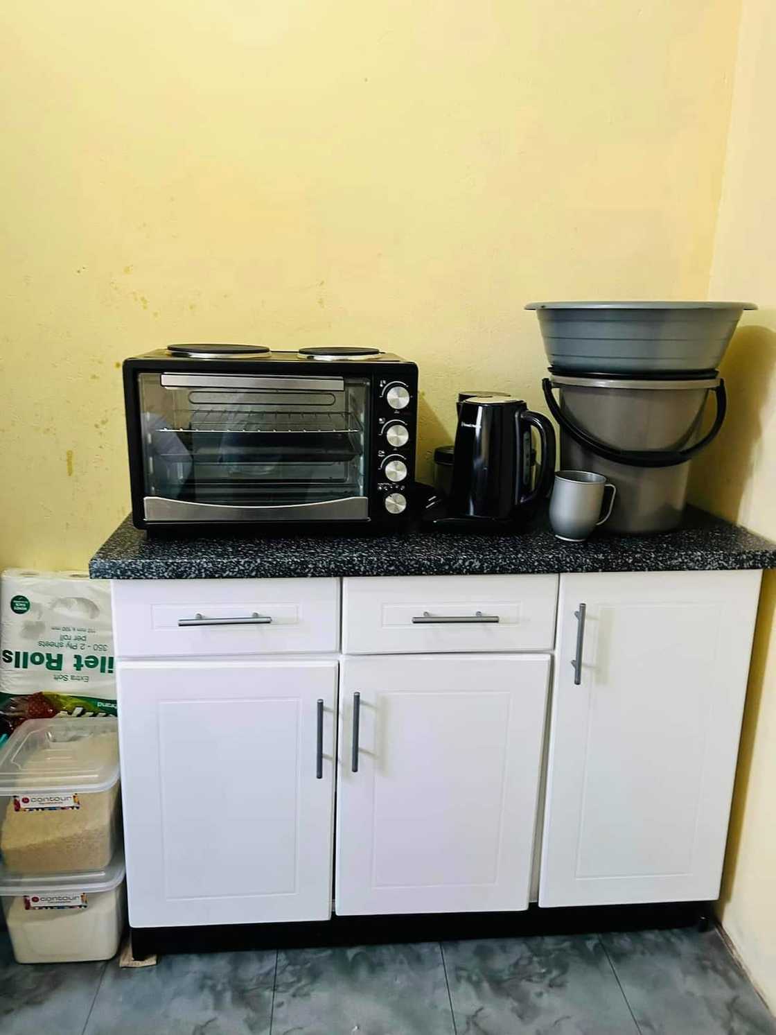 Young hun shows view of her kitchen space