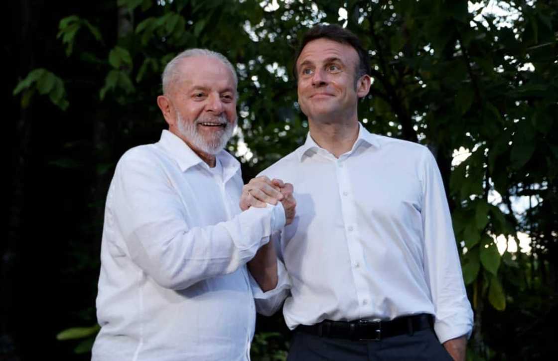 Brazilian President Luiz Inacio Lula Da Silva (L) and French President Emmanuel Macron smile together at Combu Island, Brazil, on March 26, 2024