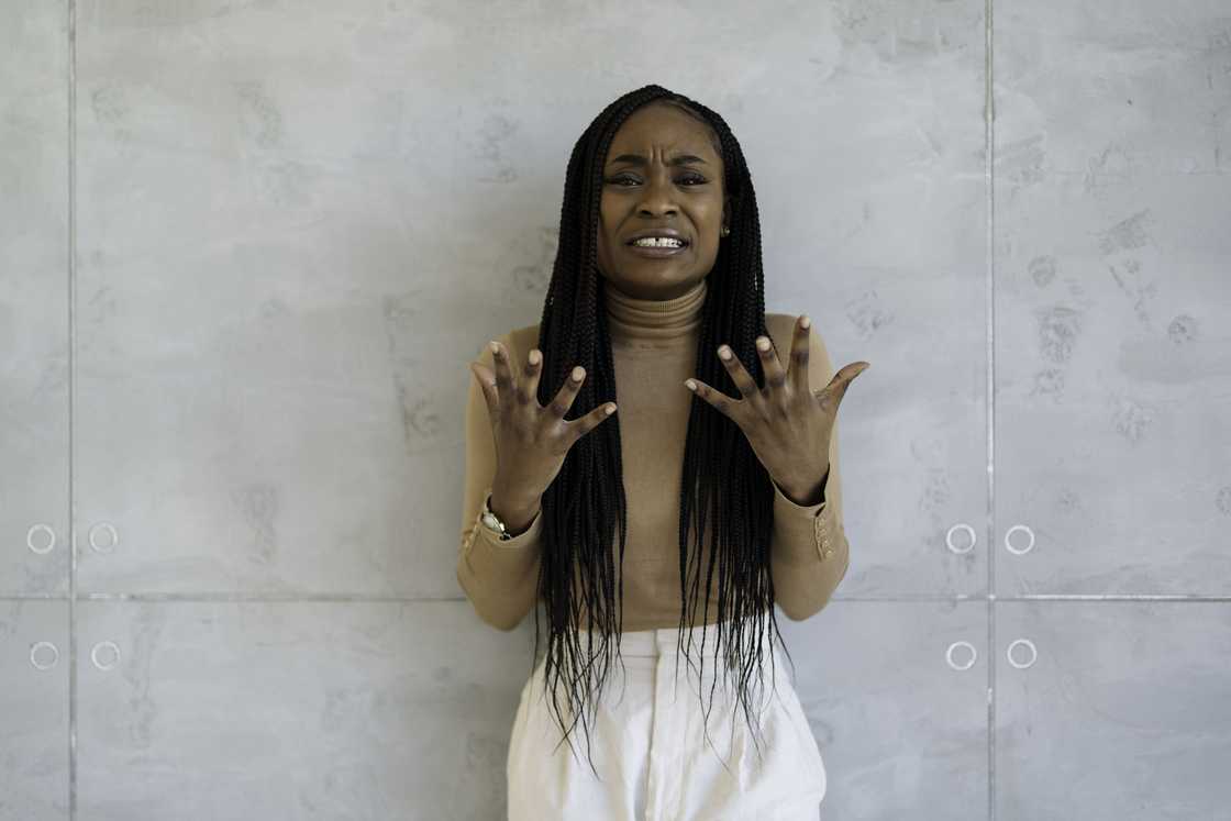 A worried woman yelling at someone in a room