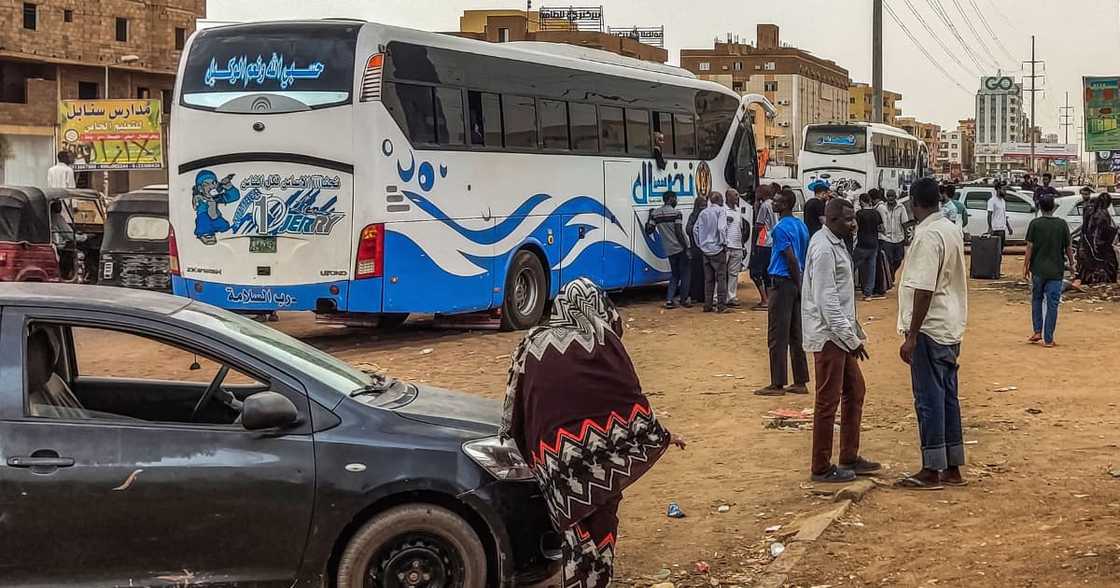 People prepare to board a bus departing from Khartoum in the Sudanese capital's south on April 24, 2023, as battles rage in the city between the army and paramilitaries People prepare to board a bus departing from Khartoum in the Sudanese capital's south on April 24, 2023, as battles rage in the city between the army and paramilitaries