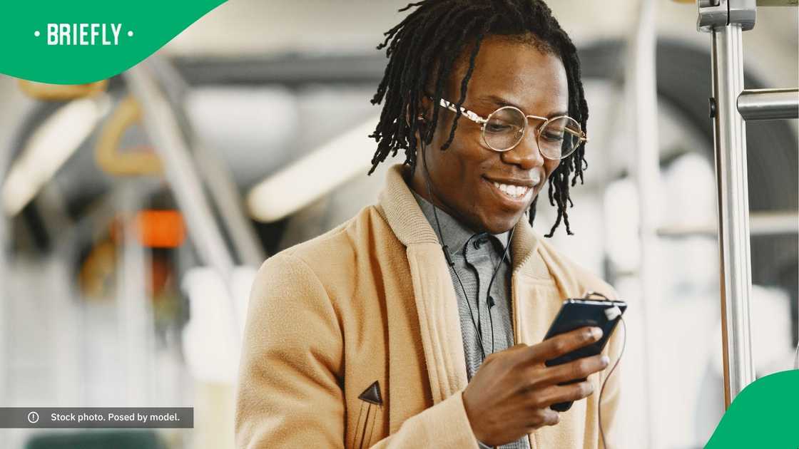 A man smiling at his phone.