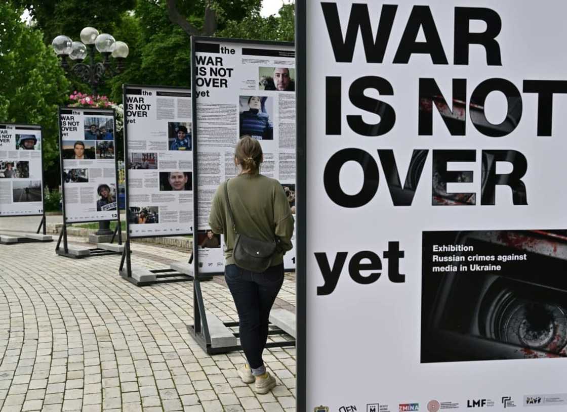 Portraits of reporters and media workers who have become victims of the conflict stare down at passersby from large black and white boards in the capital's centre Portraits of reporters and media workers who have become victims of the conflict stare down at passersby from large black and white boards in the capital's centre