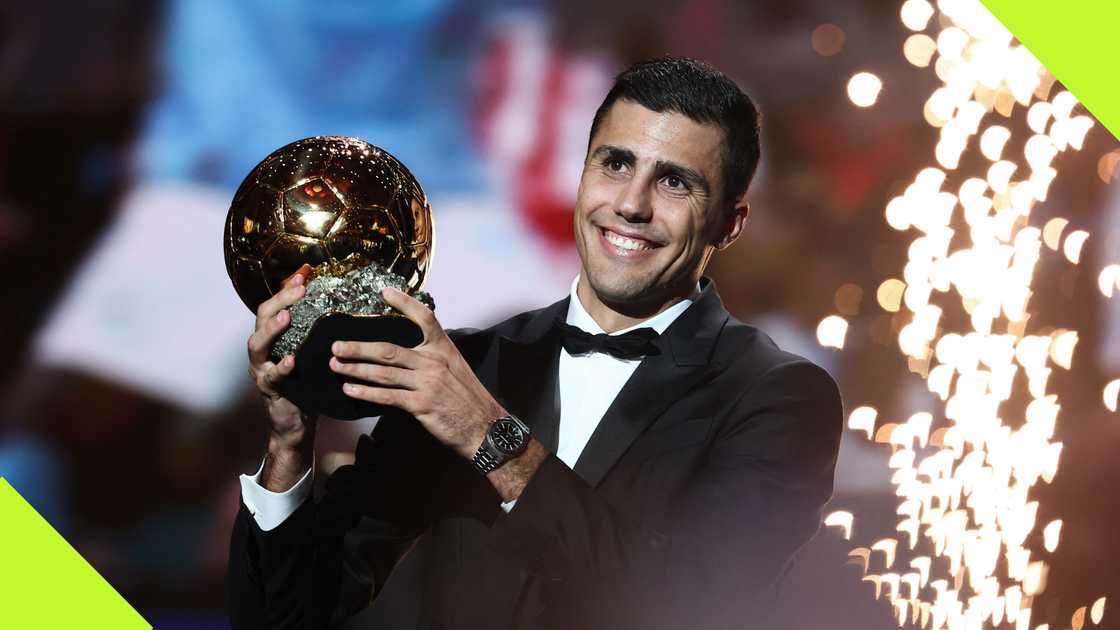 Rodri hoists the Ballon d'Or Award after edging Vinicius Junior to the coveted prize.