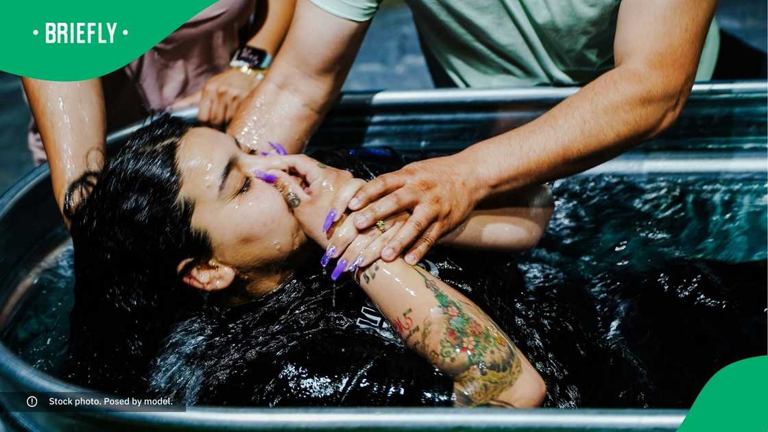 A woman getting baptised.