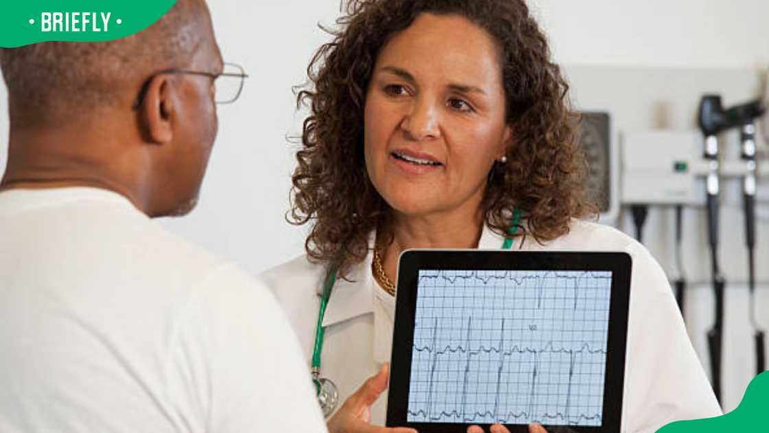 Doctor showing patient test results Doctor showing patient test results