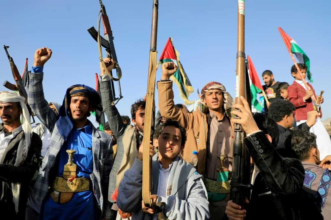 Huthi fighters brandish weapons during a protest in Sanaa on January 12, 2024 following US and British forces strikes targeting the Yemeni rebel group Huthi fighters brandish weapons during a protest in Sanaa on January 12, 2024 following US and British forces strikes targeting the Yemeni rebel group