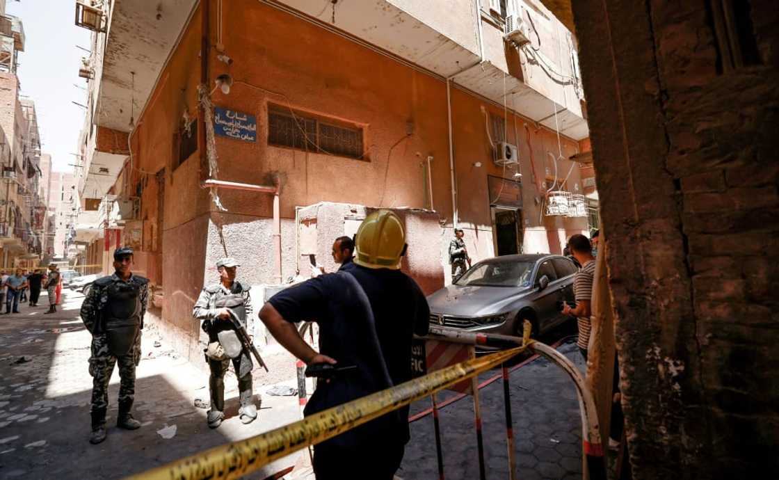 Egyptian police gather outside the Abu Sifin church after the blaze blamed on an electrical fault Egyptian police gather outside the Abu Sifin church after the blaze blamed on an electrical fault