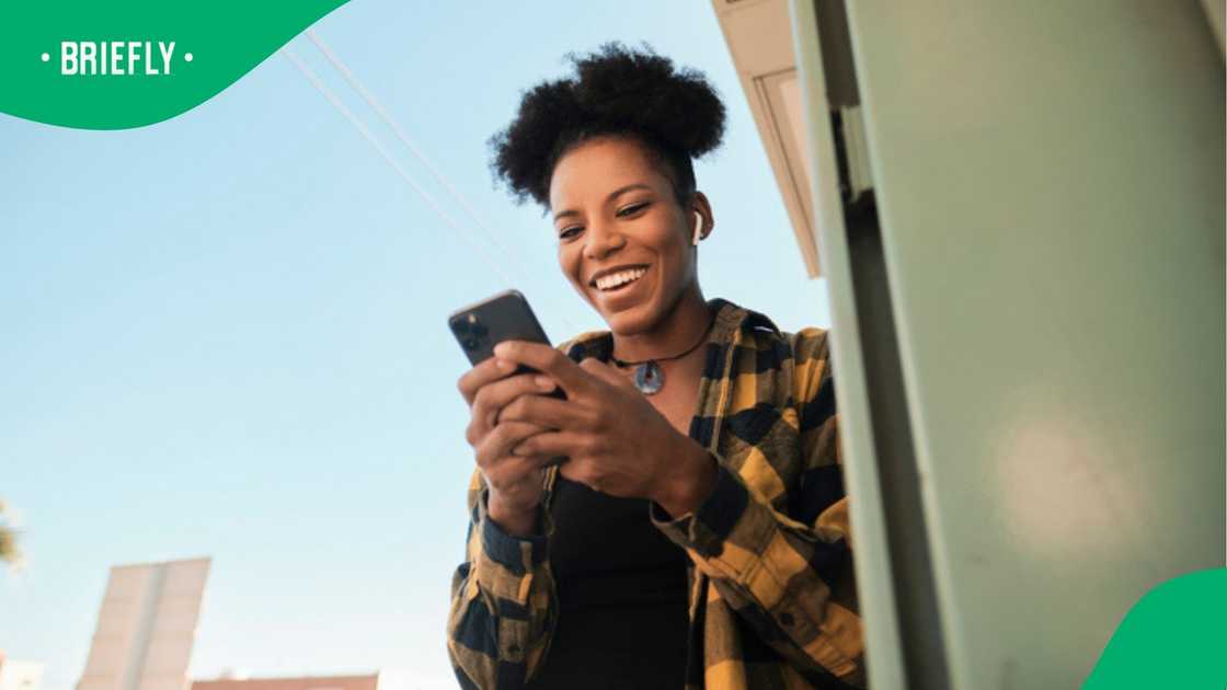 A woman laughed as she stared through her phone. A woman laughed as she stared through her phone.