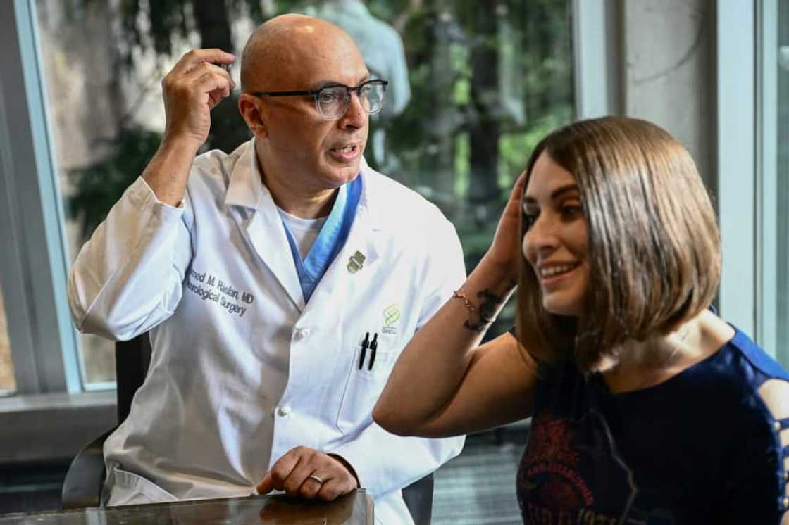 Dr. Ahmed Raslan, professor of neurological surgery, talks about the placement of a brain implant with patient Amber Pearson Dr. Ahmed Raslan, professor of neurological surgery, talks about the placement of a brain implant with patient Amber Pearson