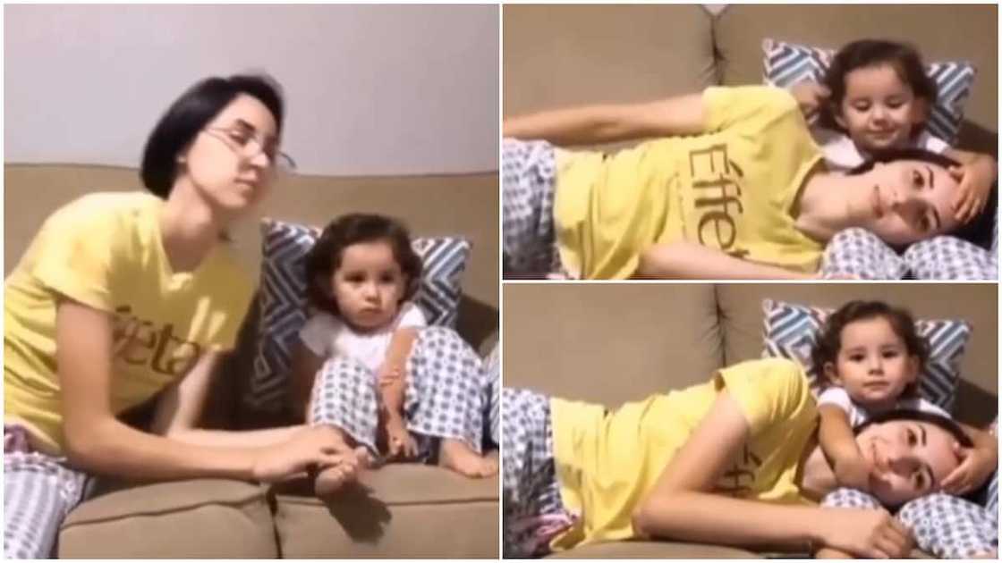 Beautiful moment mother rests on baby’s legs, she pats her head in lovely way