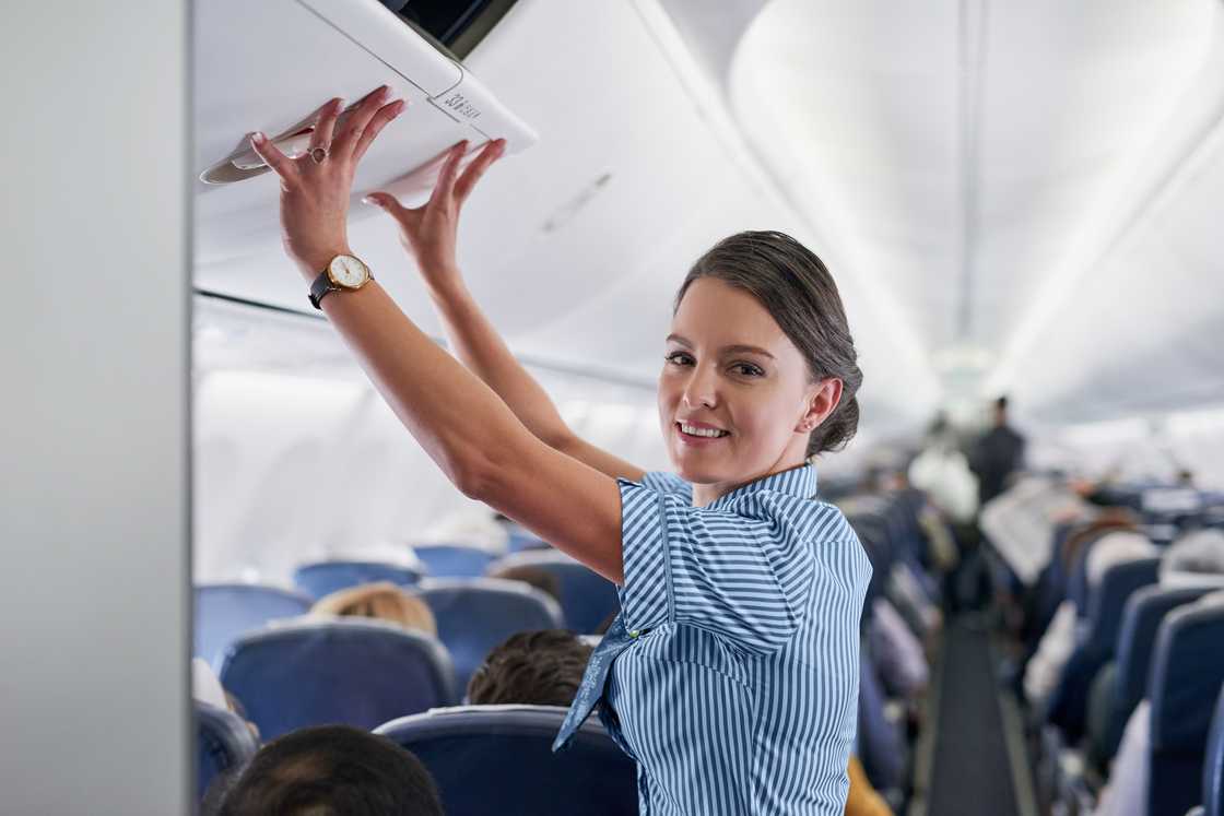 A flight attendant on a plane A flight attendant on a plane