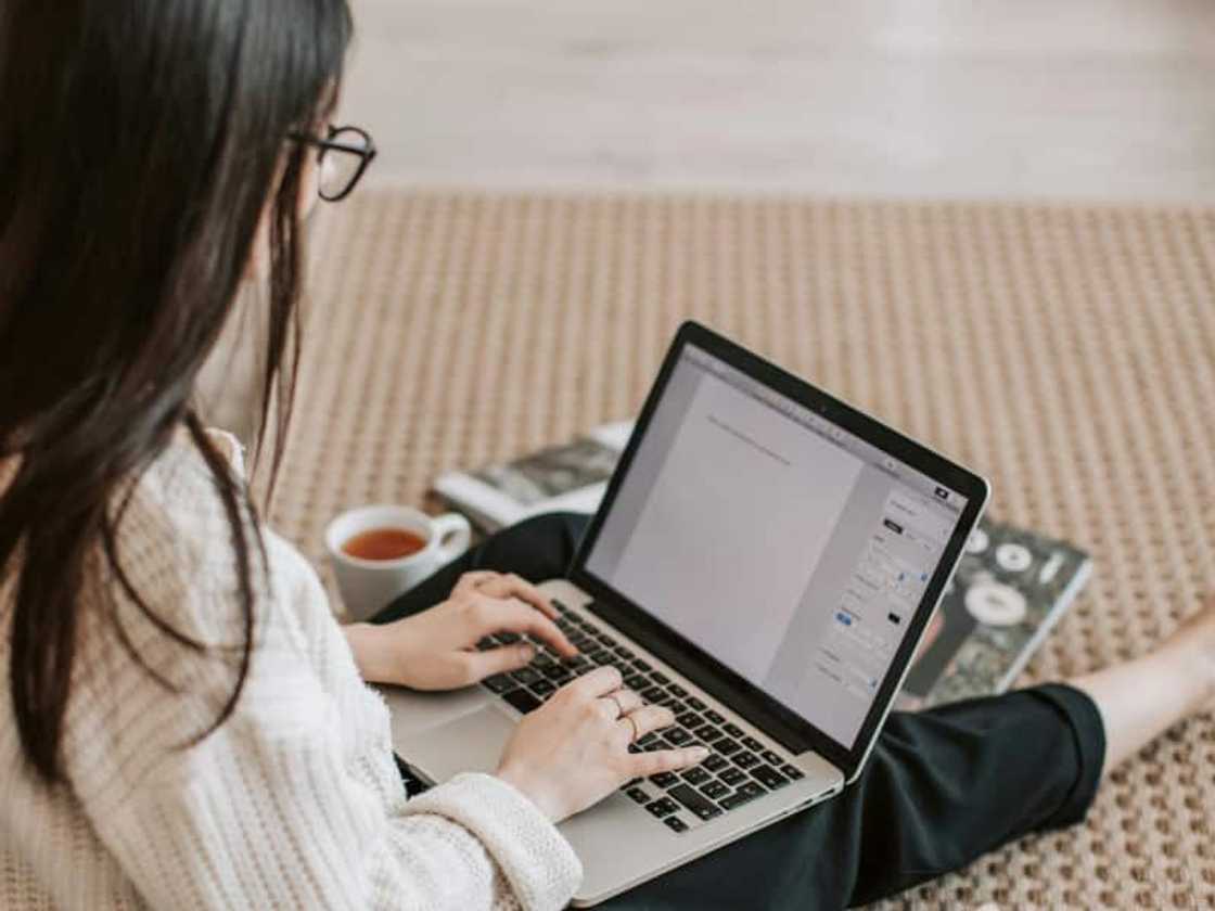 A woman typing on a laptop