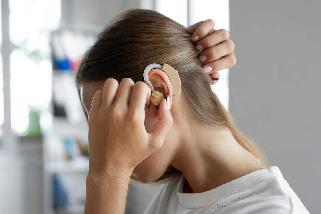 A woman wearing a hearing aid A woman wearing a hearing aid