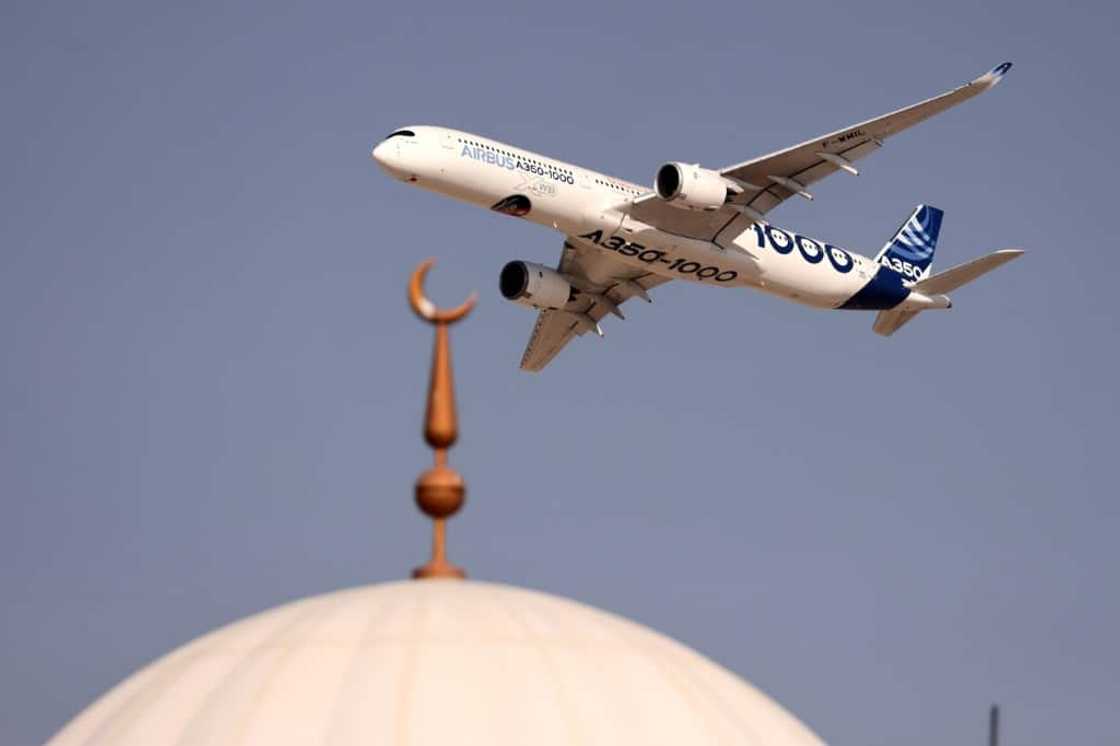An Airbus A350-1000 aircraft flies above a mosque during the ongoing Dubai Airshow An Airbus A350-1000 aircraft flies above a mosque during the ongoing Dubai Airshow