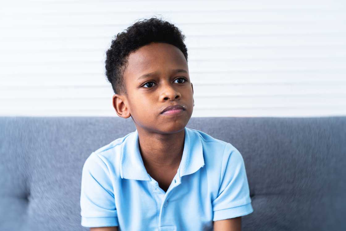 A disappointed teenage boy sitting at home A disappointed teenage boy sitting at home