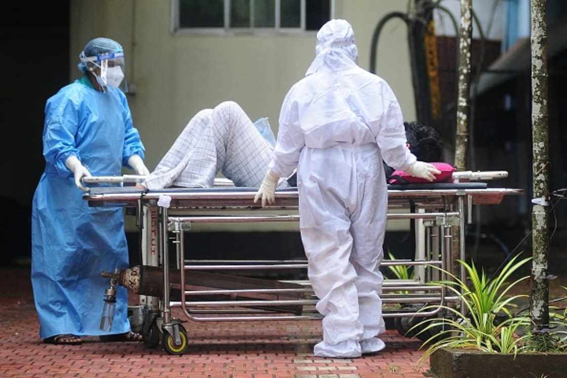 Health workers wearing protective gear shift a man with symptoms of the Nipah virus to an isolation ward. Health workers wearing protective gear shift a man with symptoms of the Nipah virus to an isolation ward.