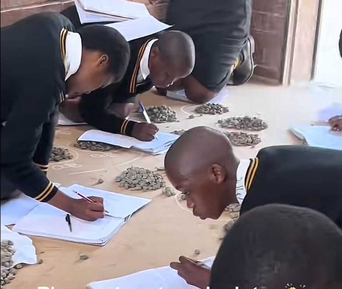 A TikTok video shows school pupils sitting on the floor and using stones to calculate their maths work. A TikTok video shows school pupils sitting on the floor and using stones to calculate their maths work.