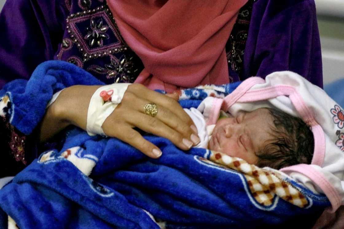 A mother and her newborn baby at the UNFPA-supported Sexual and Reproductive Health (SRH) clinic in the Zaatari camp for Syrian refugees A mother and her newborn baby at the UNFPA-supported Sexual and Reproductive Health (SRH) clinic in the Zaatari camp for Syrian refugees