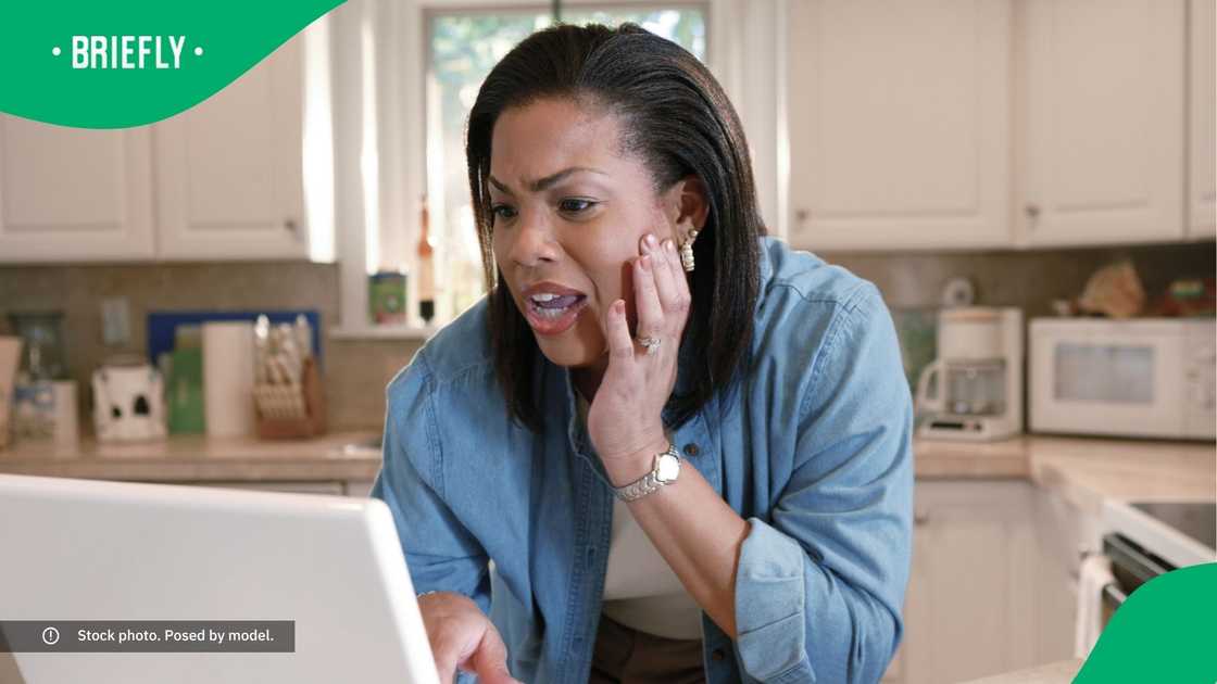 A shocked woman looking at her laptop. A shocked woman looking at her laptop.