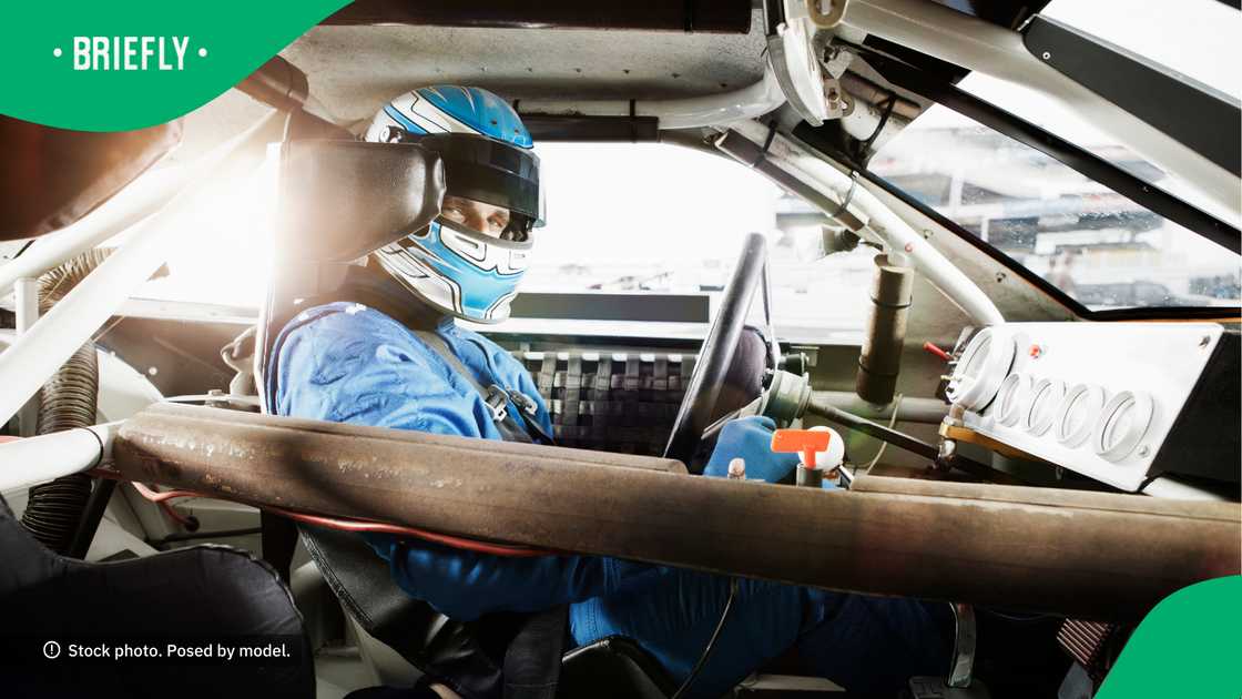 People were able to get a view of the race car driver in his car. People were able to get a view of the race car driver in his car.