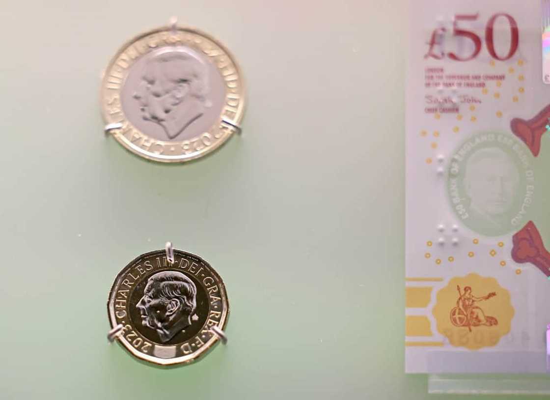 Banknotes and coins featuring King Charles III's image are pictured on display during a photocall for 'The Future of Money' exhibition, at the Bank of England Museum in London on February 27, 2024 Banknotes and coins featuring King Charles III's image are pictured on display during a photocall for 'The Future of Money' exhibition, at the Bank of England Museum in London on February 27, 2024