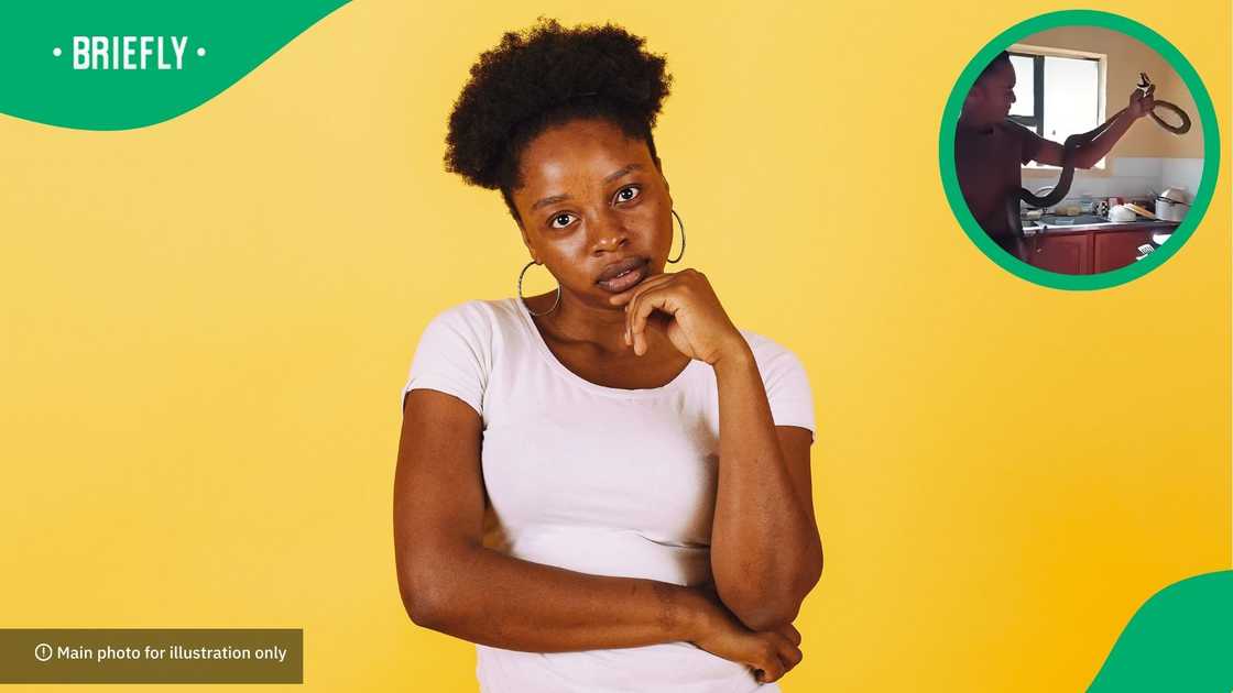 The man used a pinning stick to extract it, as it was deep inside the drawer The man used a pinning stick to extract it, as it was deep inside the drawer