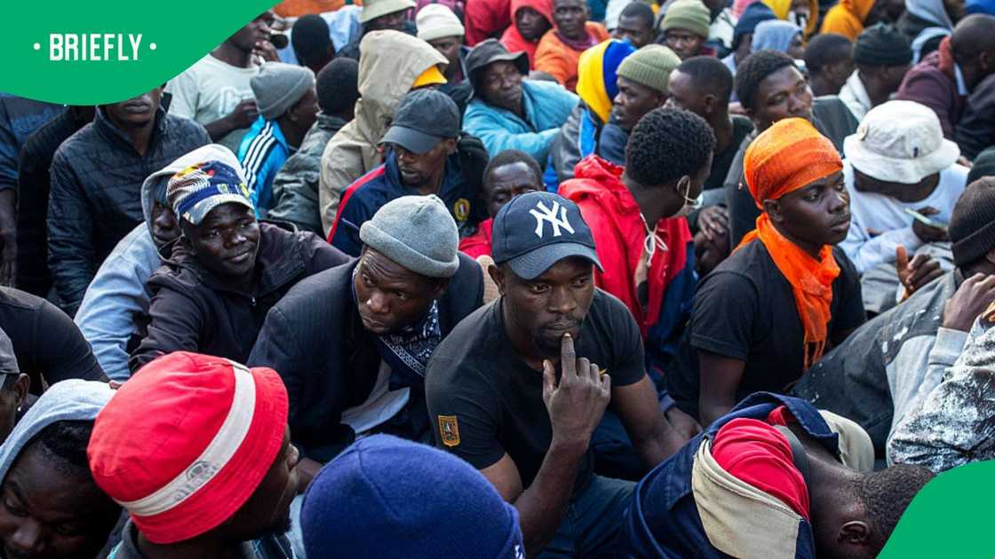 Men wait to be processed by South African immigration authorities as thousands of Malawians take refuge on June 20, 2026 in Sherwood Park outside Durban, South Africa Men wait to be processed by South African immigration authorities as thousands of Malawians take refuge on June 20, 2026 in Sherwood Park outside Durban, South Africa