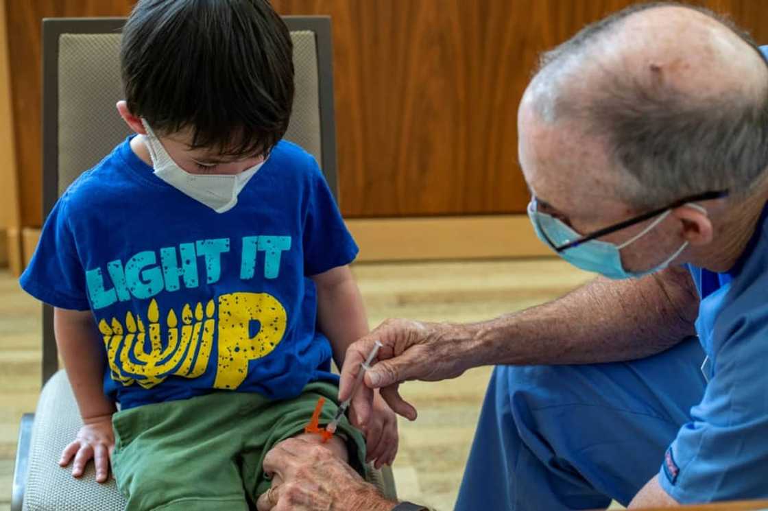 A three year old receives his Covid-19 vaccination in Needham, Massachusetts A three year old receives his Covid-19 vaccination in Needham, Massachusetts
