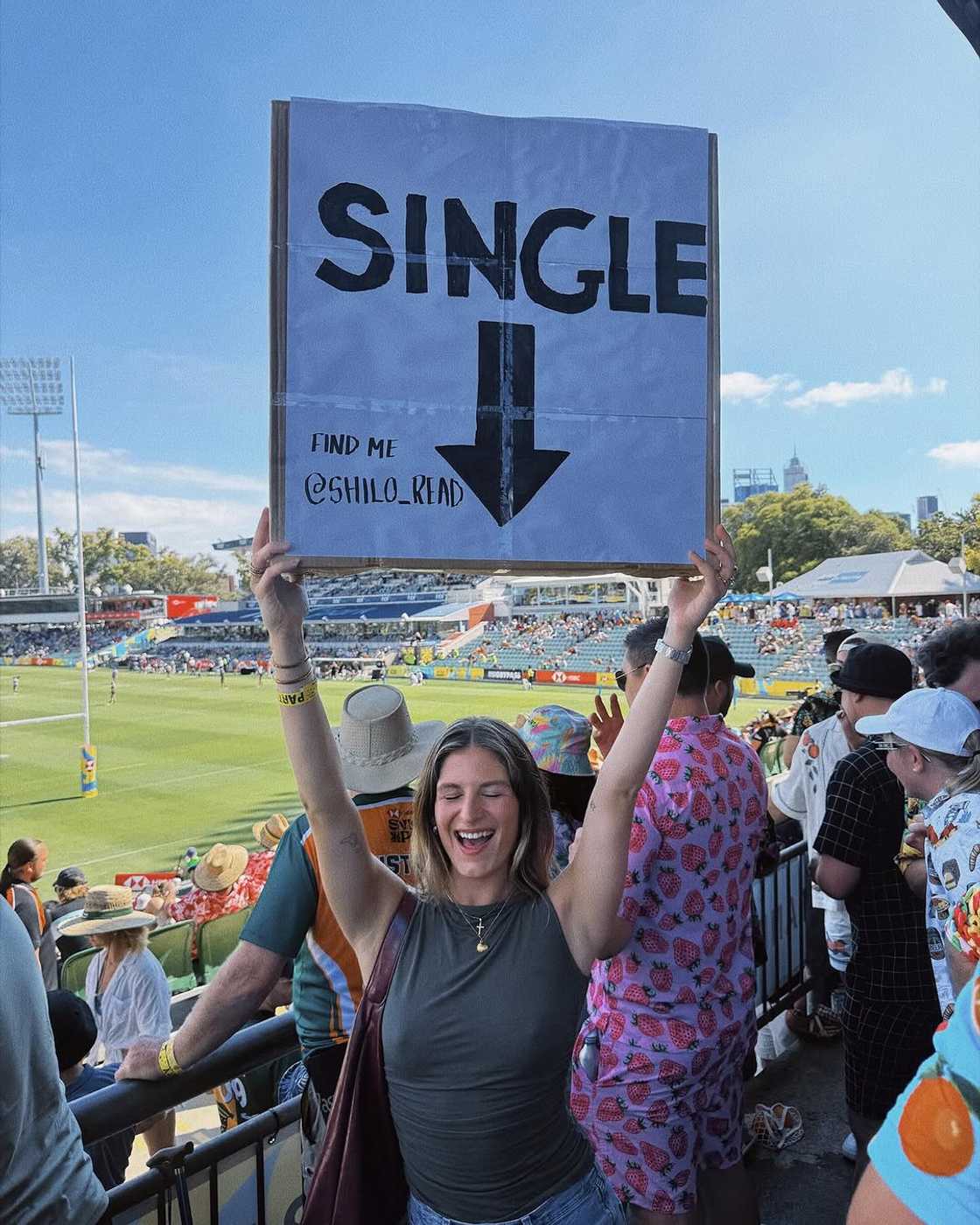 A woman brought a 'single' sign to a sporting event. A woman brought a 'single' sign to a sporting event.
