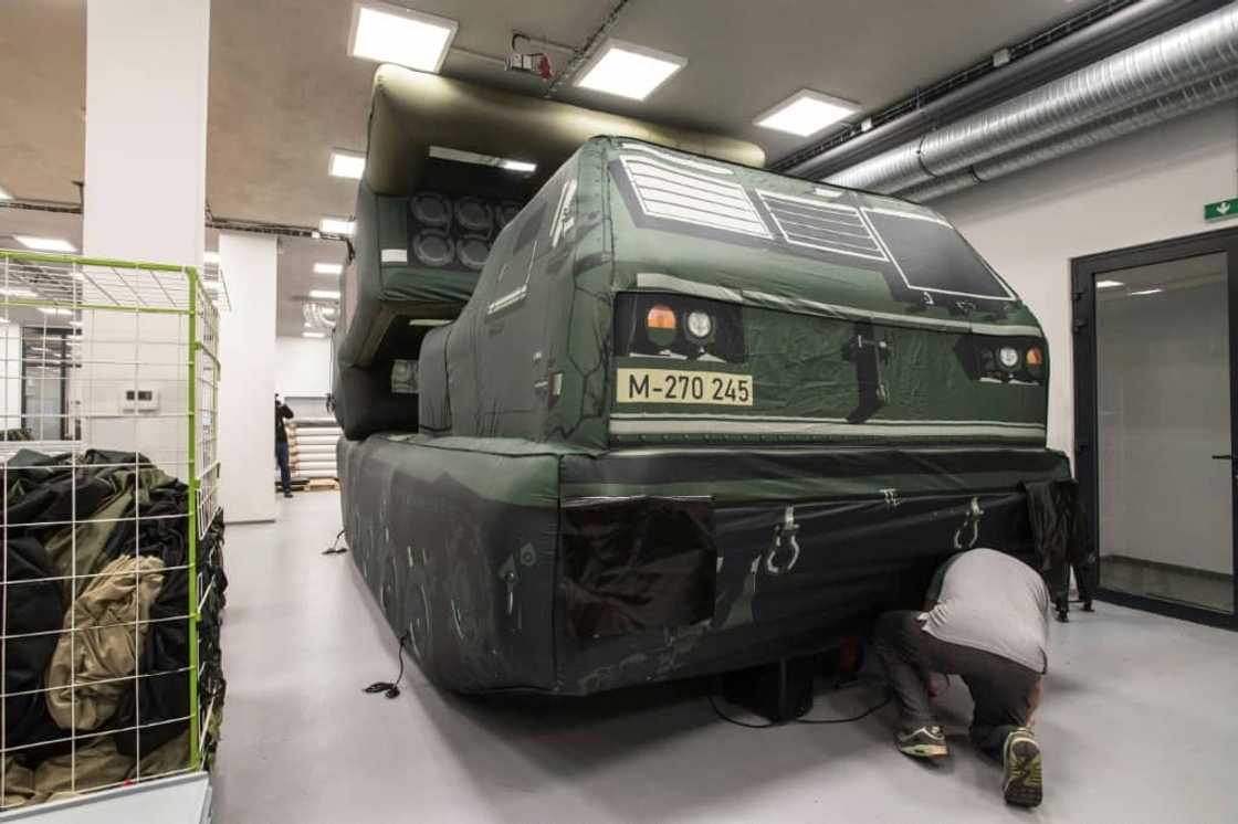 An inflatable Himars military vehicle being checked