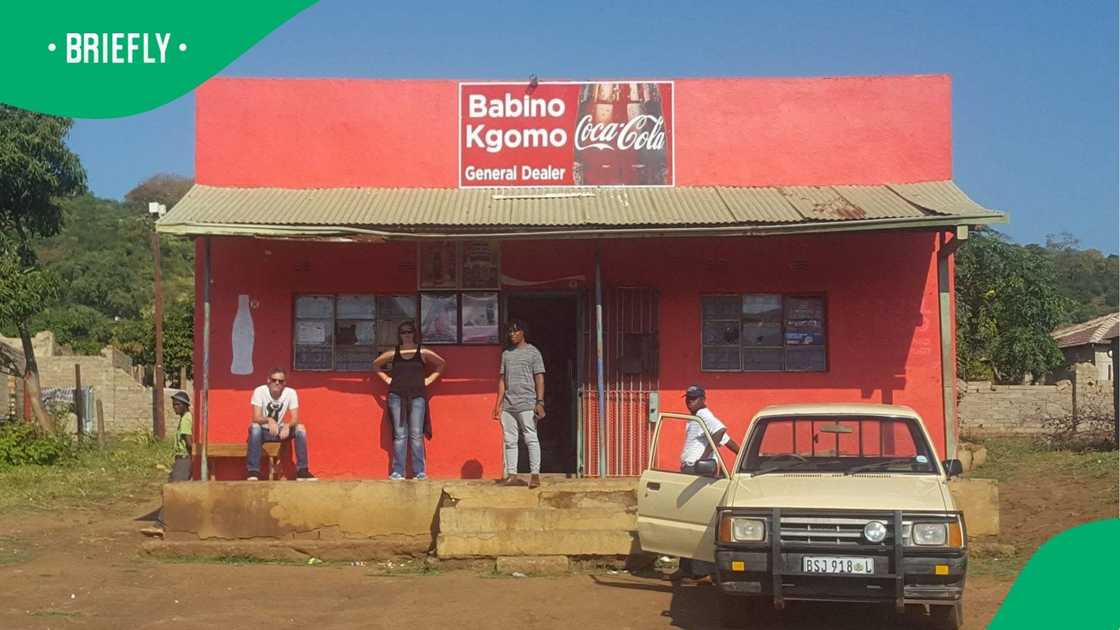 The image showed a few people standing outside what used to be a shop owned by locals The image showed a few people standing outside what used to be a shop owned by locals