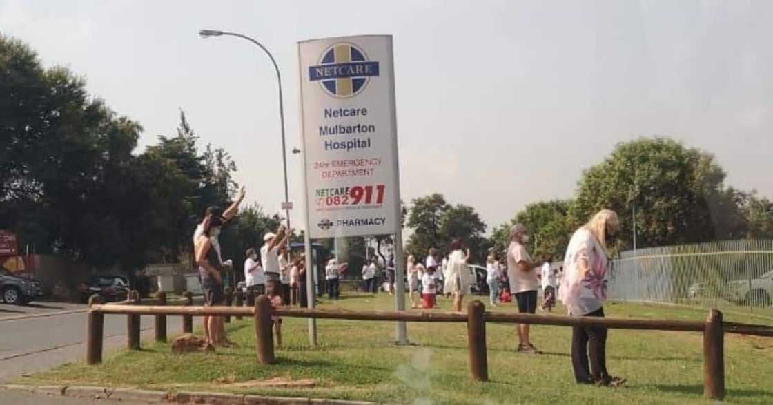 Community gathers to pray outside hospital, Covid-19