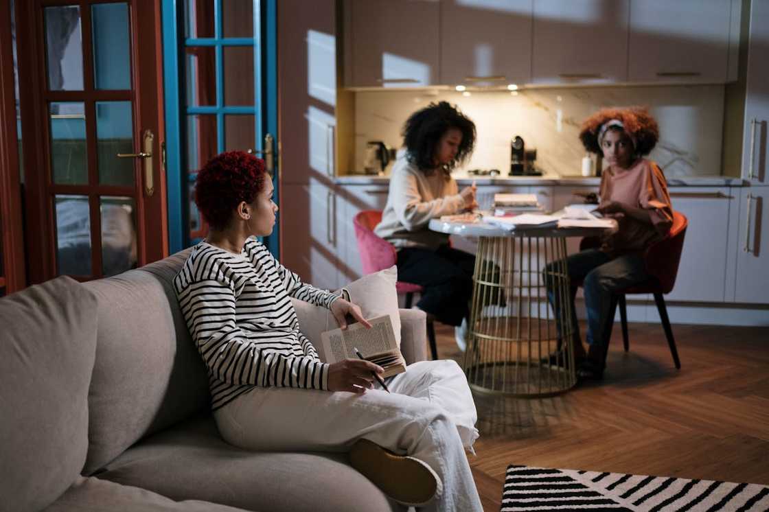 A group of young women sitting in a modern apartment during a retreat session.