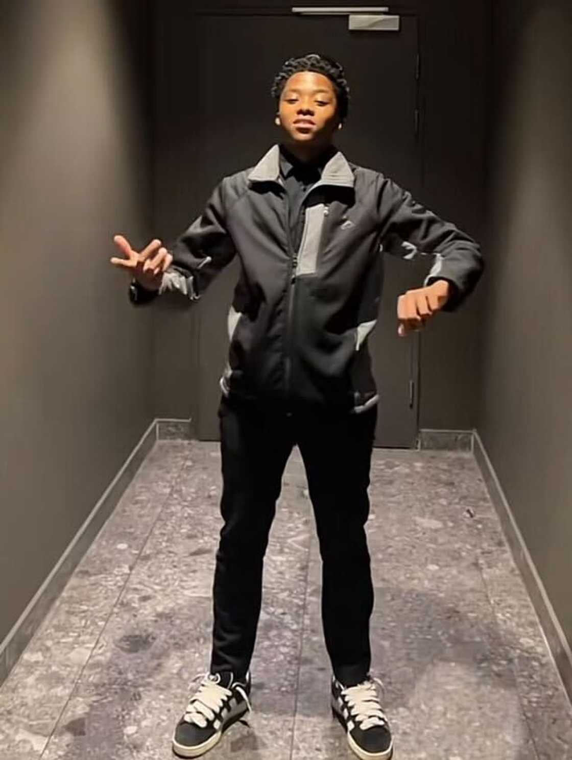 A young man posed in a TikTok video while creating content. A young man posed in a TikTok video while creating content.