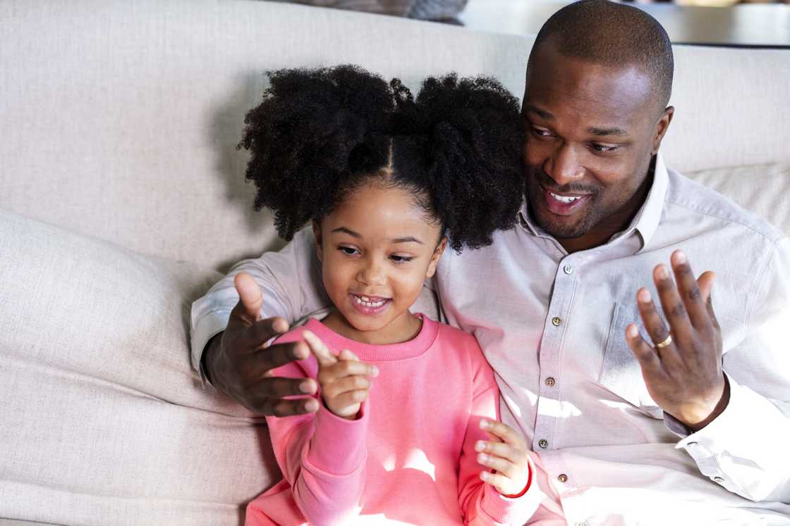 A father and daughter using sign language