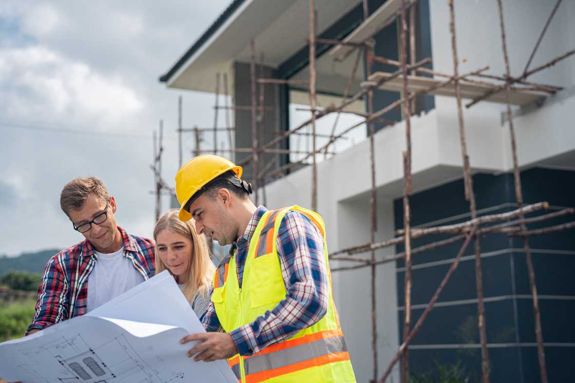 An American couple were briefed by the contractor about the building construction of their home An American couple were briefed by the contractor about the building construction of their home