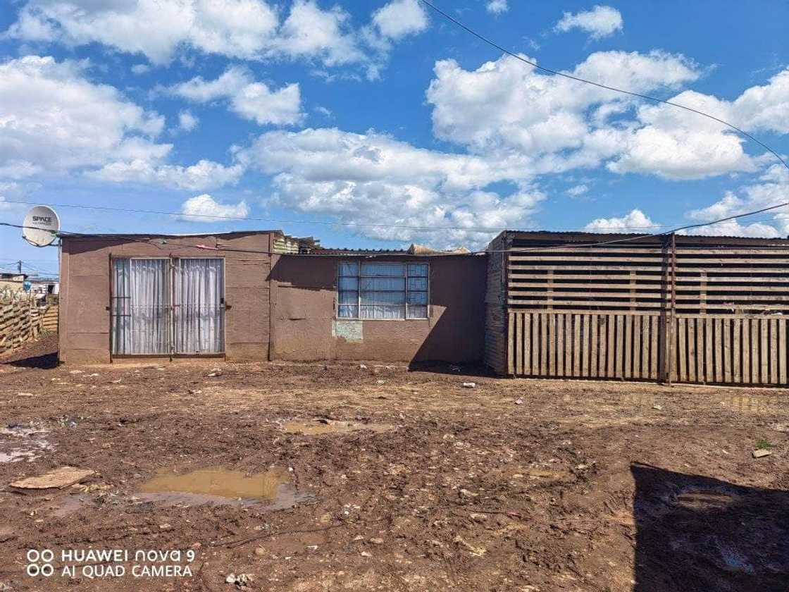 Eastern Cape woman showcases the outside of her shack.