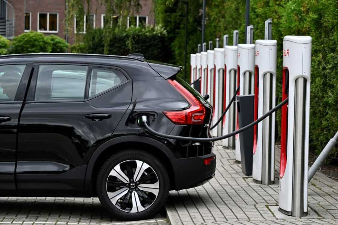 An electric car charges at a charging point reserved for Tesla cars