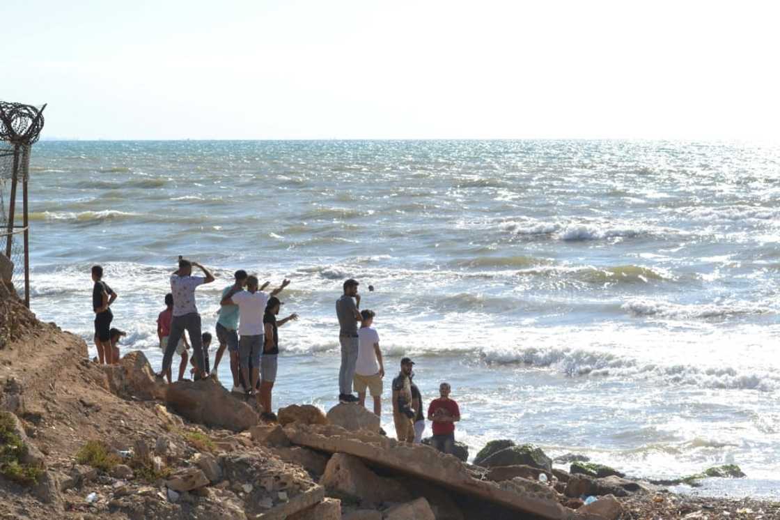 Lebanese men look towards the sea near the Arida border crossing with Syria Lebanese men look towards the sea near the Arida border crossing with Syria