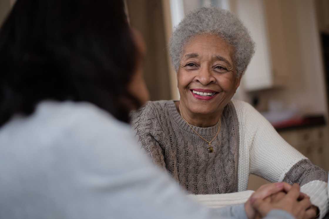 A South African gogo busted dance moves in front of policemen. A South African gogo busted dance moves in front of policemen.