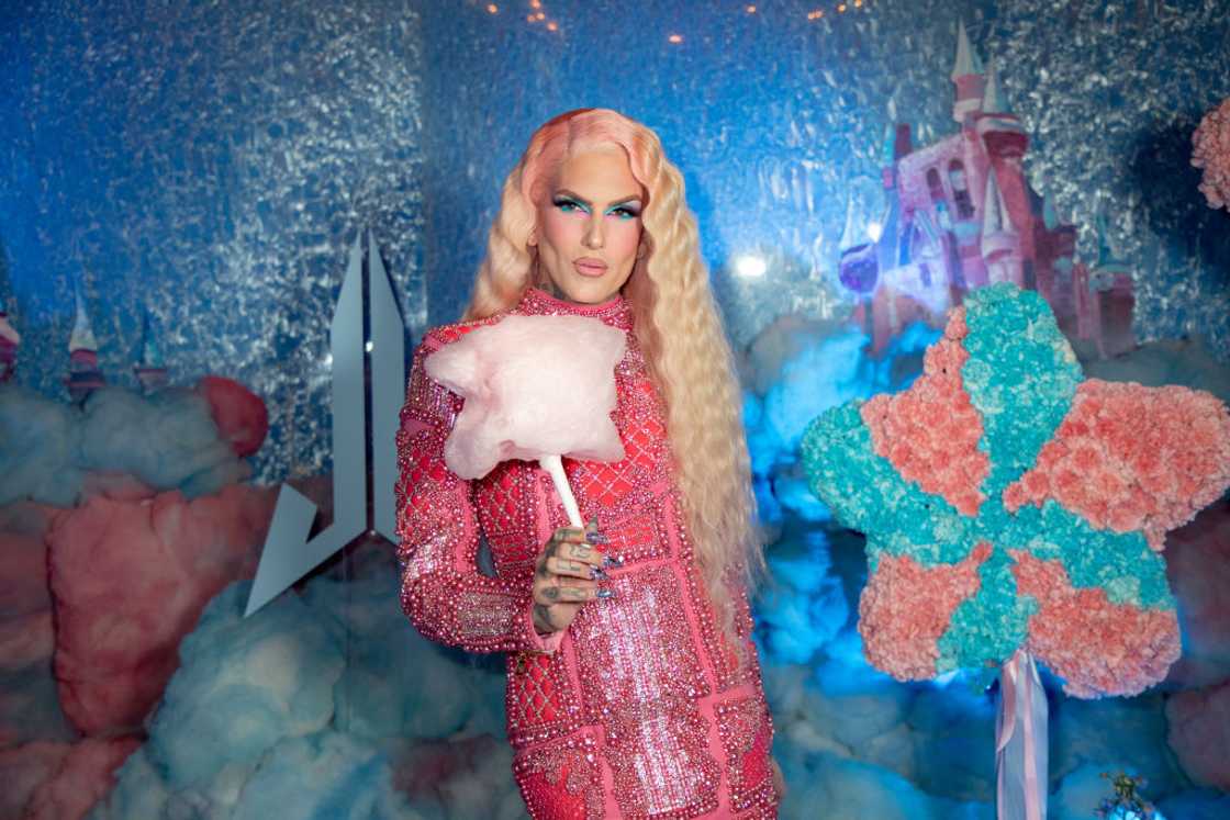 Jeffree Star wearing a bedazzled pink gown holding a pink cotton candy at a product launch Jeffree Star wearing a bedazzled pink gown holding a pink cotton candy at a product launch