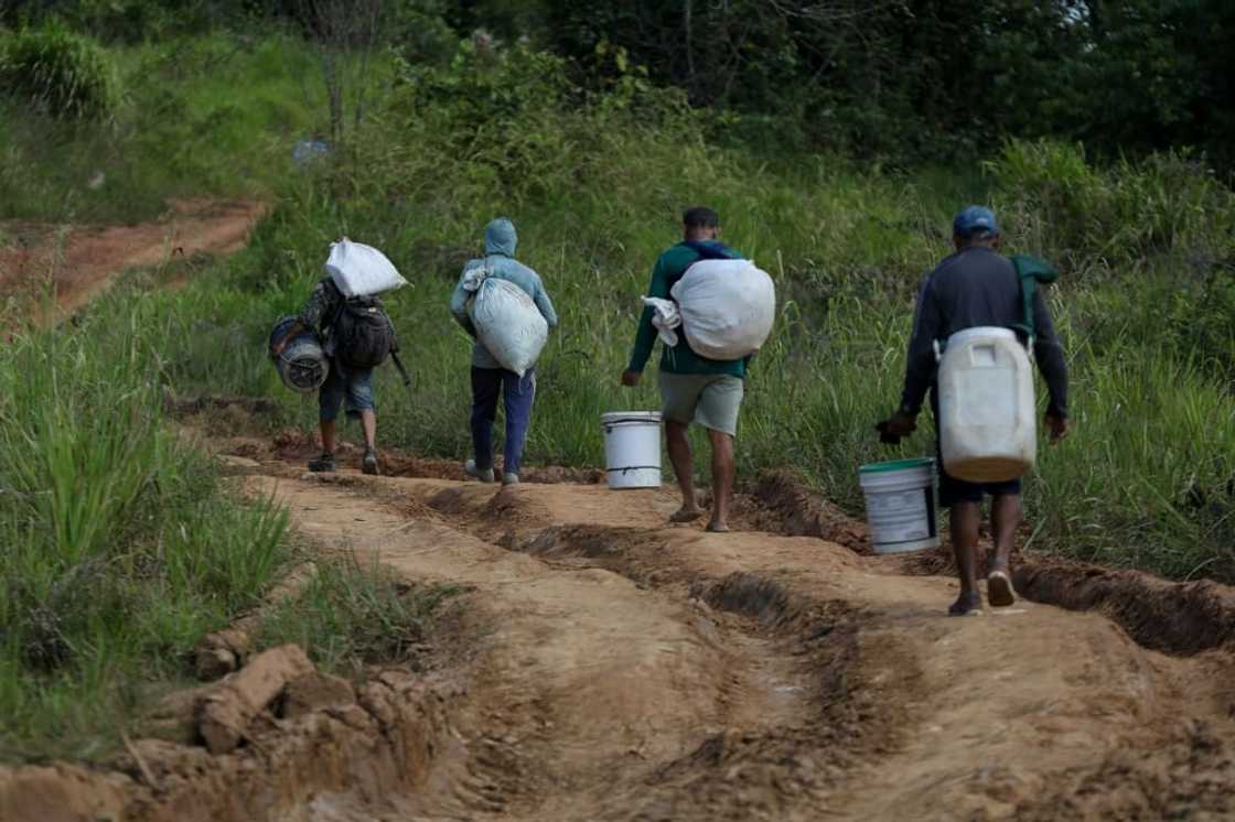 Alleged illegal miners leave a mining area inside Yanomami indigenous land Alleged illegal miners leave a mining area inside Yanomami indigenous land