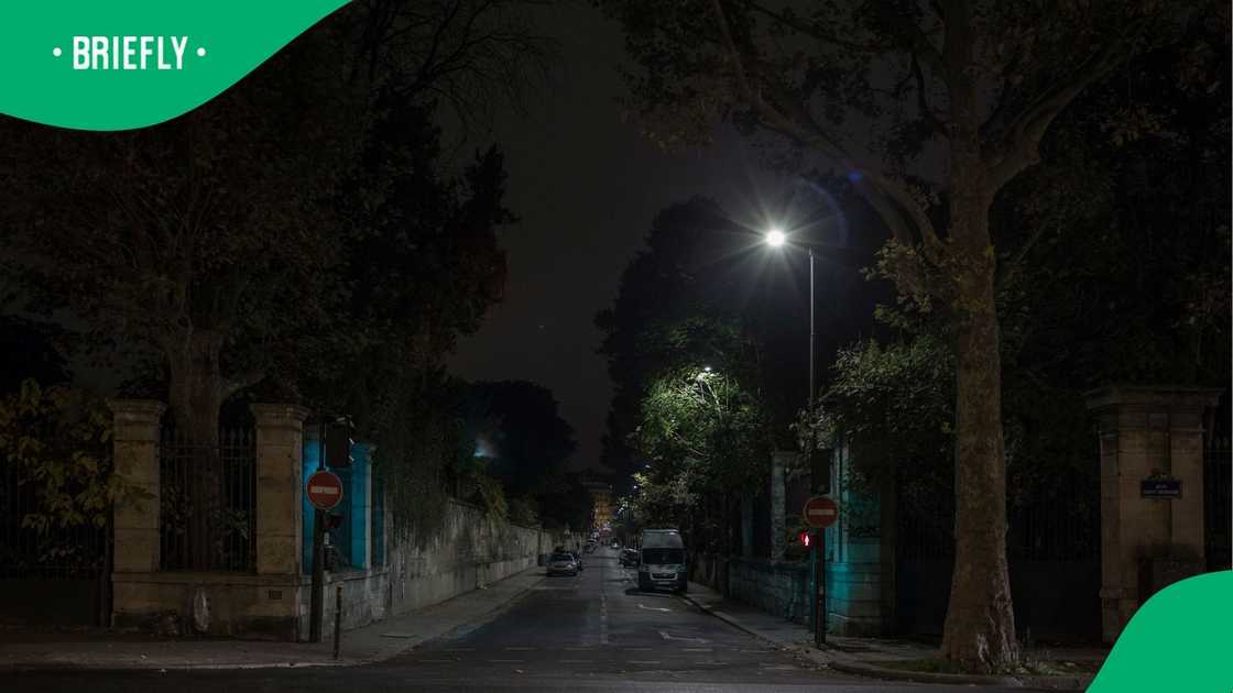 A stock photo of a quiet street at night