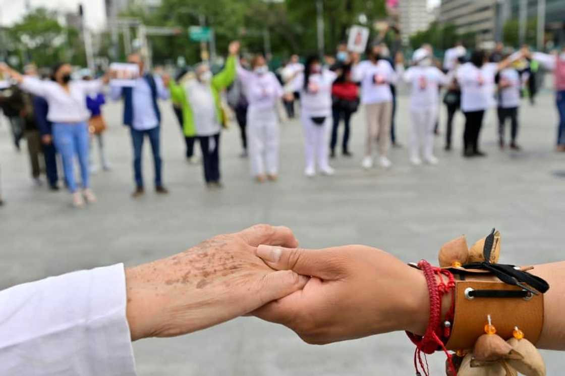 People with missing relatives take part in a pre-Hispanic ritual during a protest against violence, in Mexico City on July 5, 2022